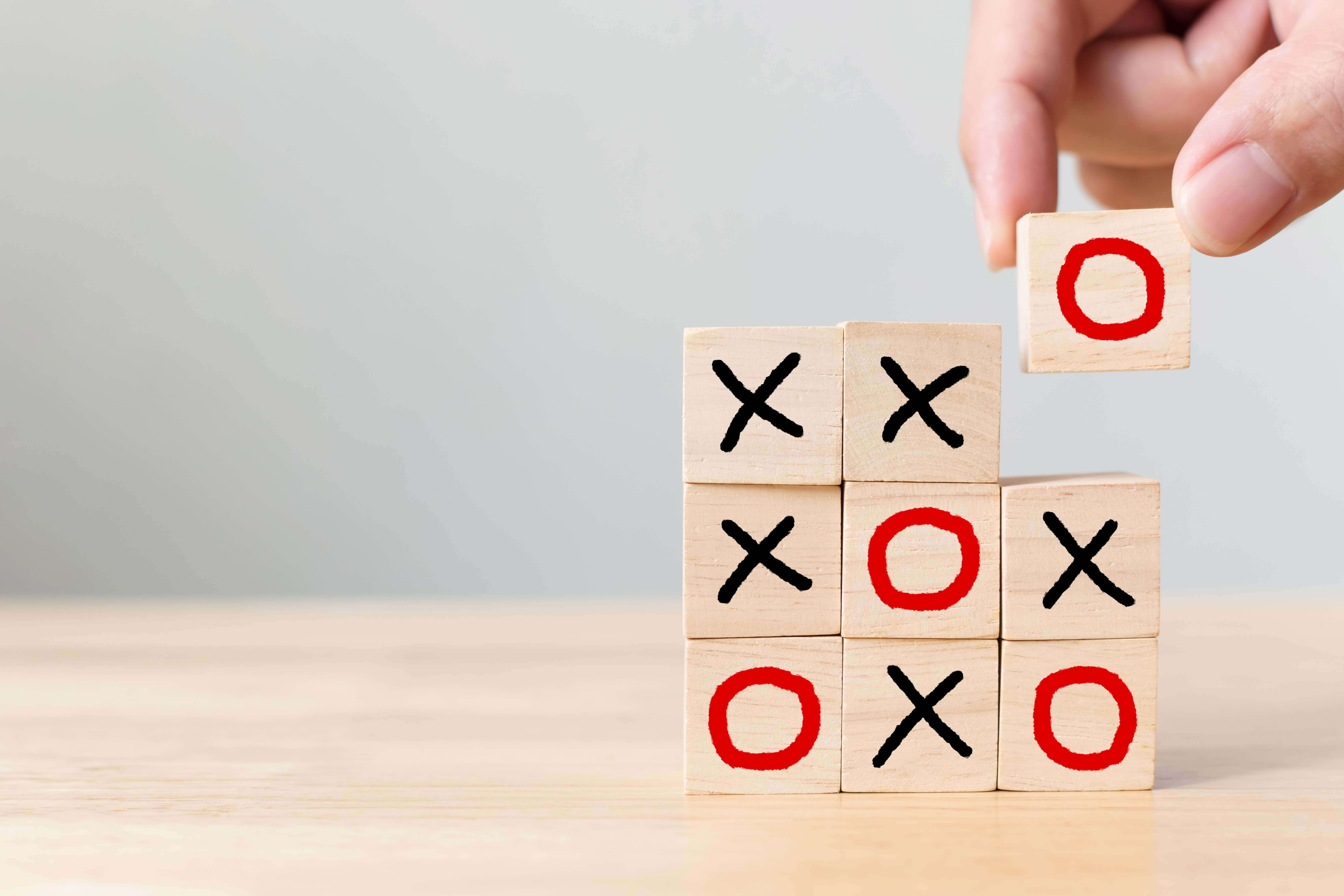 Business marketing strategy planning concept. Wooden block tic tac toe board game on wood table